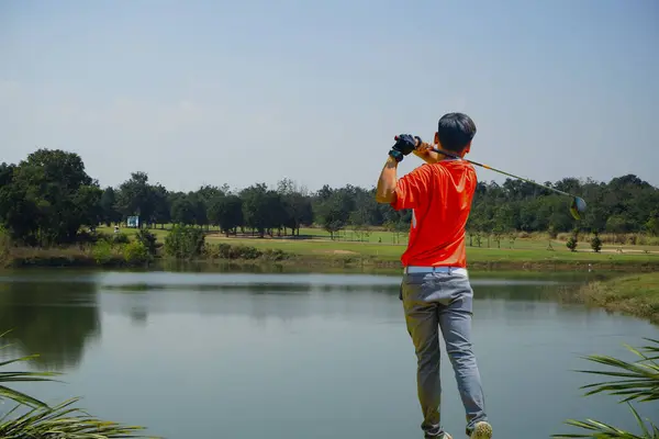 ゴルファーは夕方のゴルフ場でゴルフをします 太陽の下でゴルフコースでゴルフをしている男 — ストック写真