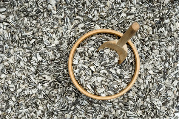 Tigela de madeira com sementes de girassol e colher — Fotografia de Stock
