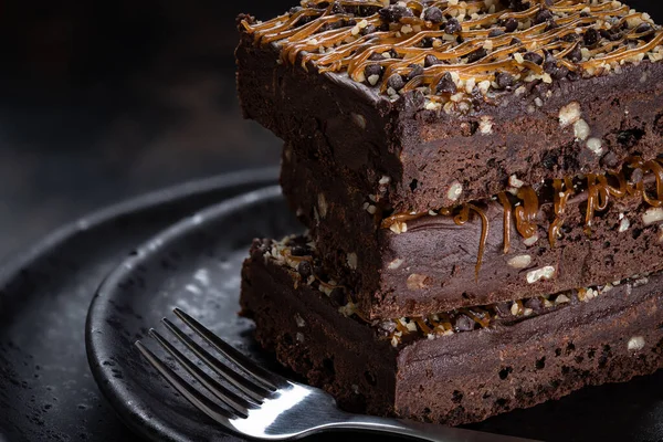 Dark Chocolate Fudge Brownies Caramel Nut Topping Stacked Plate Closeup — Stock Photo, Image