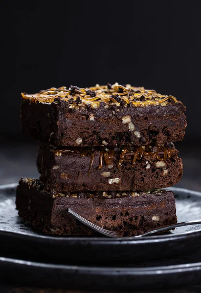 Dark Chocolate Fudge Brownies Caramel Nut Topping Stacked Plate Closeup — Stock Photo, Image