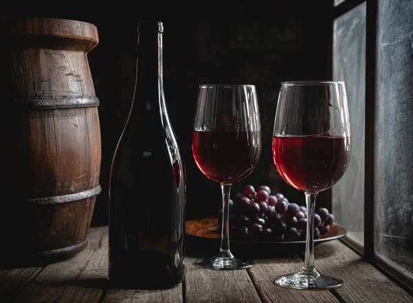 Two Glasses Red Wine Bottle Next Window Grapes Barrel Background — Stock Photo, Image