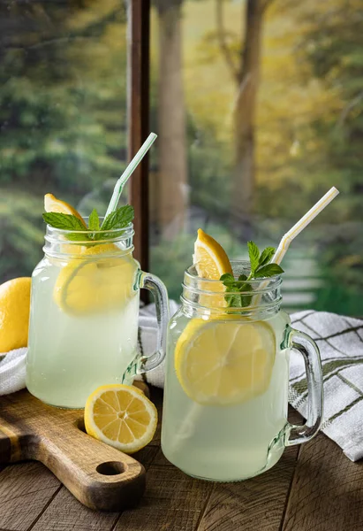 Two Glasses Lemonade Lemon Slices Wooden Table Window Rural Background — Stock Photo, Image