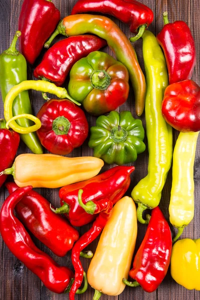 Colorful raw peppers on table - top view — Stock Photo, Image