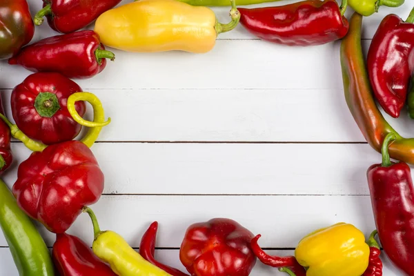 Colorful raw peppers on table - top view — Stock Photo, Image