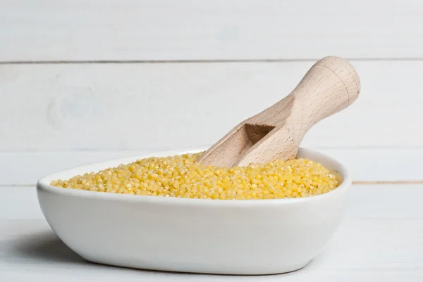 Millet groats in white bowl — Stock Photo, Image