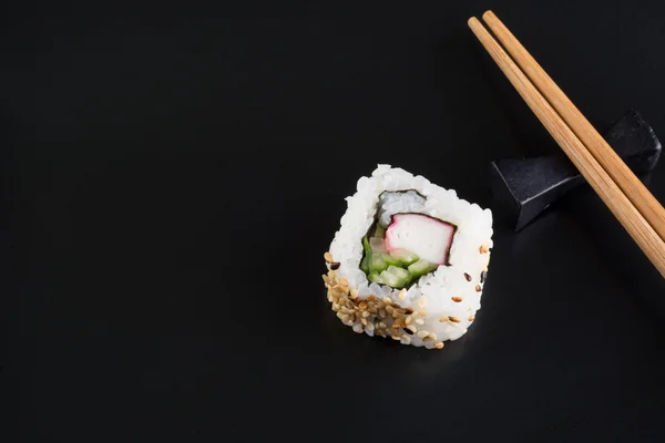 Sushi on black plate — Stock Photo, Image