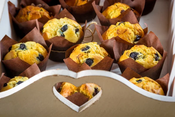 Great quantity of sweet biscuits muffins on a tray with heart. — Stock Photo, Image