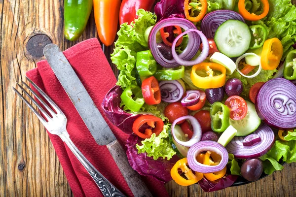 Salade de printemps aux légumes frais juteux sur une table rustique en bois — Photo