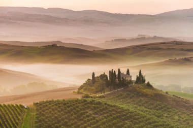 Rural landscape of Tuscany on a hazy sunny morning clipart