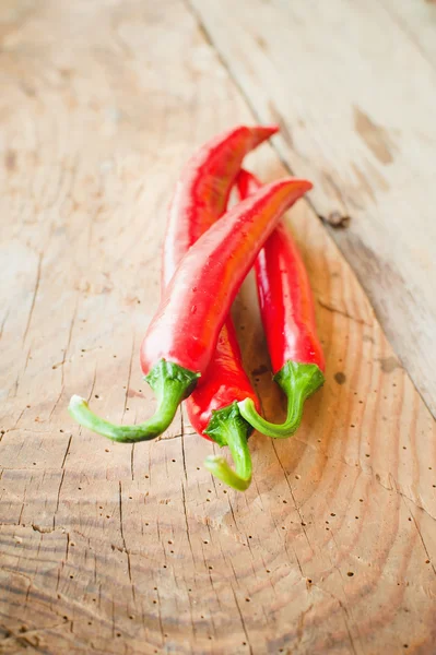 Fresh and spicy chili peppers on a wooden rustic table Vintage — Stock Photo, Image