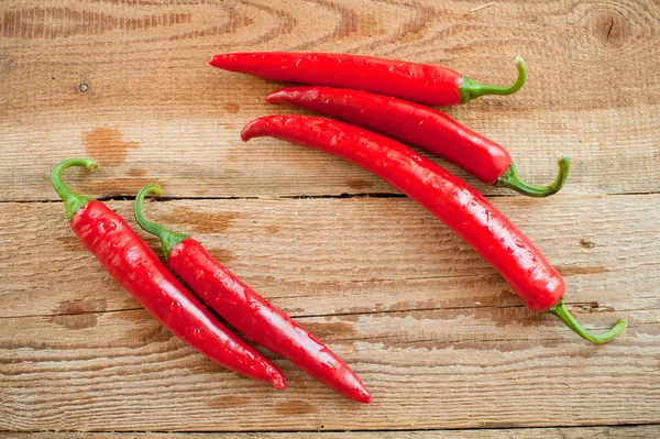 Fresh and spicy chili peppers on a wooden rustic table Vintage — Stock Photo, Image