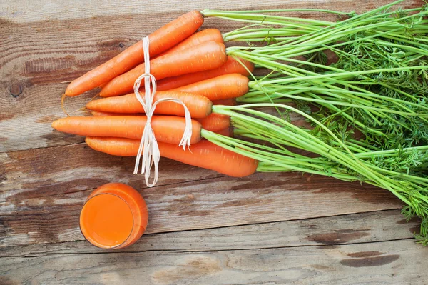 Свіжа морква і сік на дерев'яному сільському столі Вінтаж — стокове фото