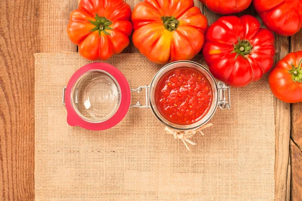 Tomates et sauce tomate, purée de tomates sur une table rustique en bois — Photo