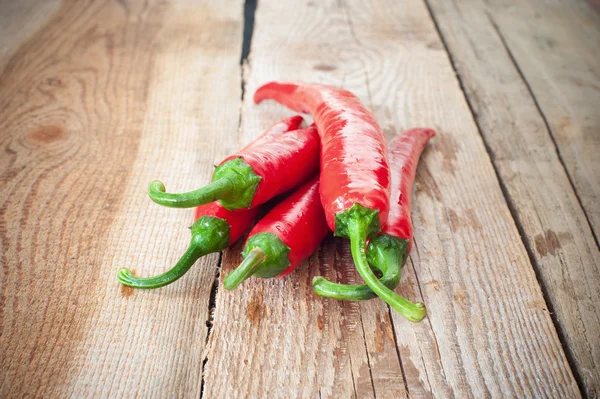Juicy and spicy peppers on a wooden rustic table — Stock Photo, Image