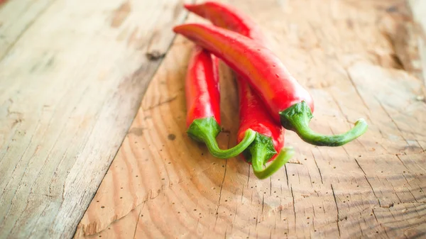 Fresh and spicy chili peppers on a wooden rustic table Vintage — Stock Photo, Image