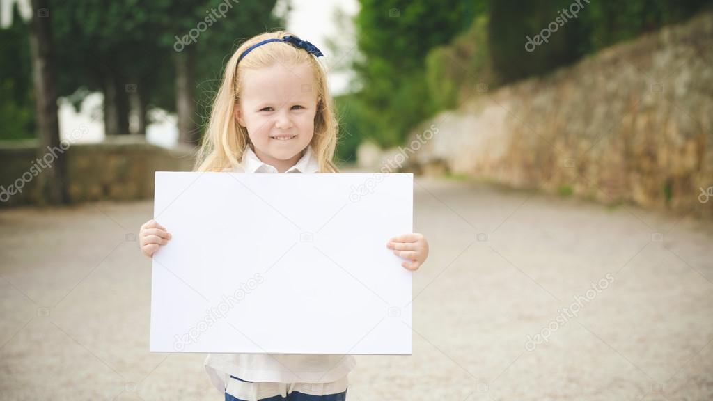 Cute little girl on the way to school with a white card