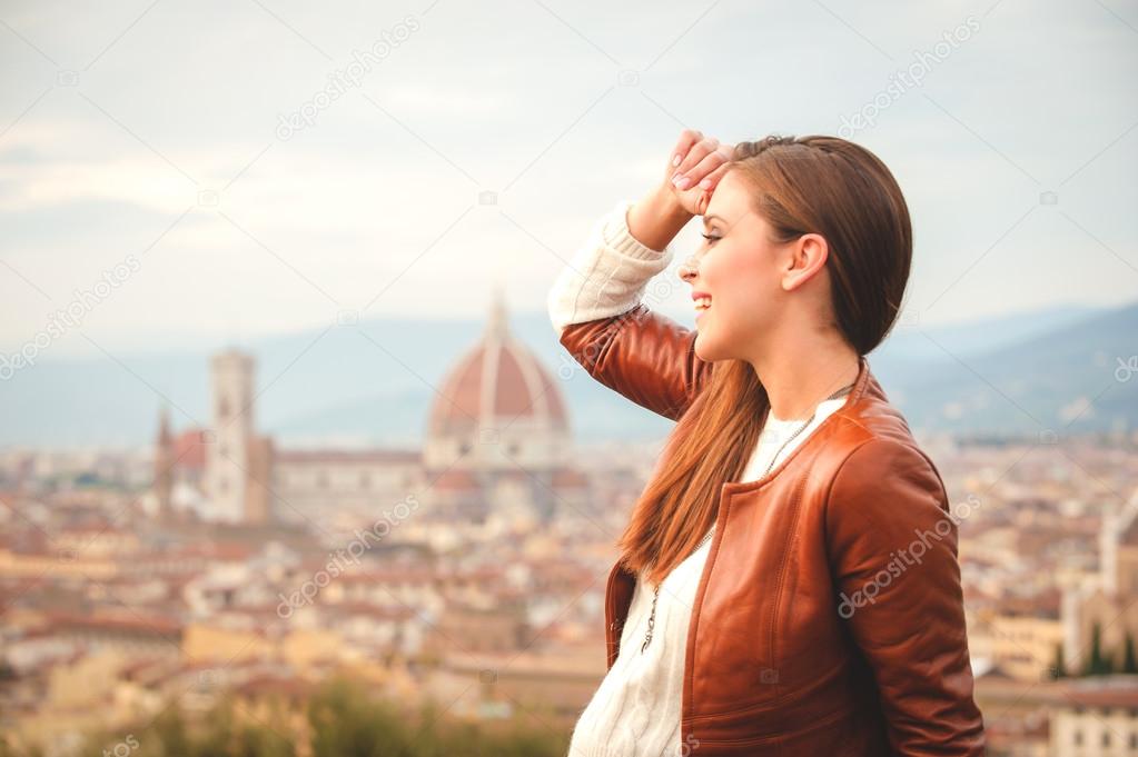Beautiful girl impressed view the panorama of Florence in autumn