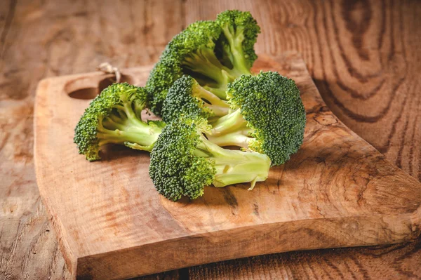 Green delicious broccoli on a wooden rustic table — Stock Photo, Image