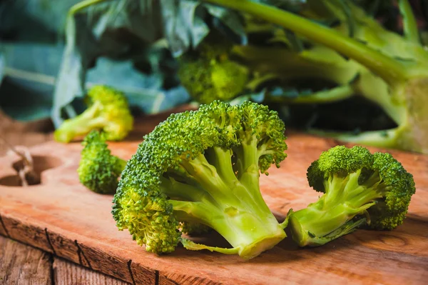 Verde delicioso brócoli en una mesa rústica de madera — Foto de Stock