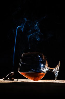 Alkol ve sigara asil puro siyah bir arka plan üzerinde bardak