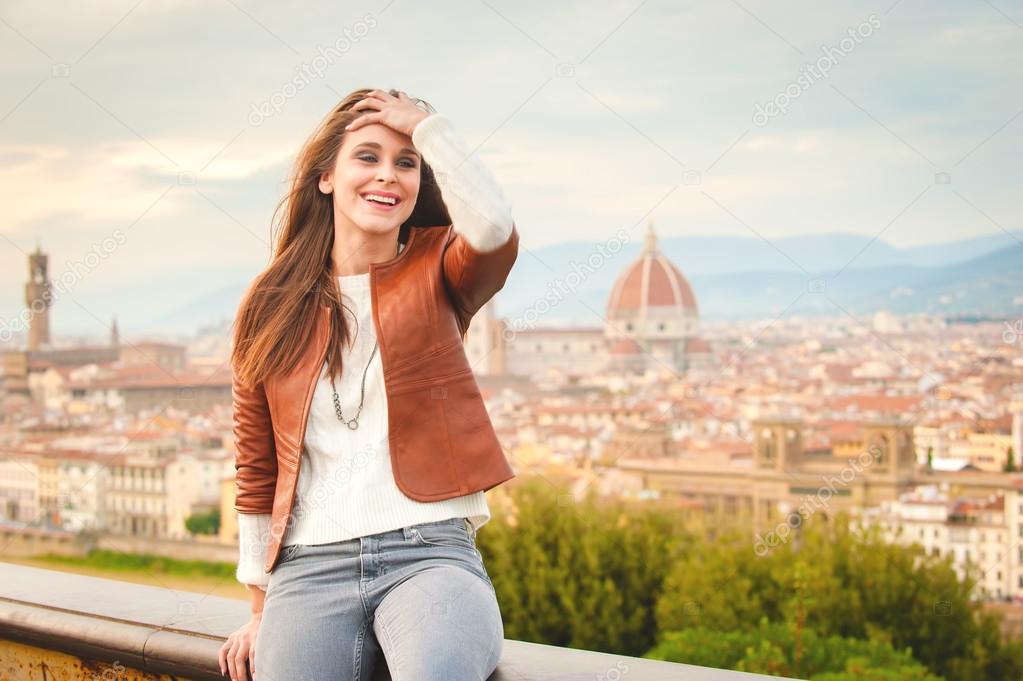 Beautiful girl impressed view the panorama of Florence in autumn