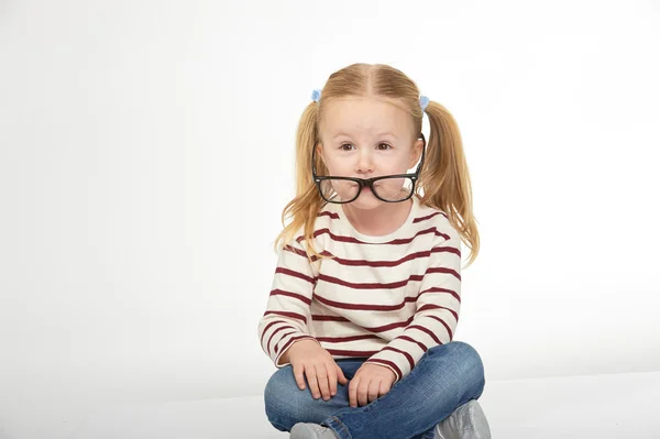 Cute little girl with glasses on a white background — Stock Photo, Image