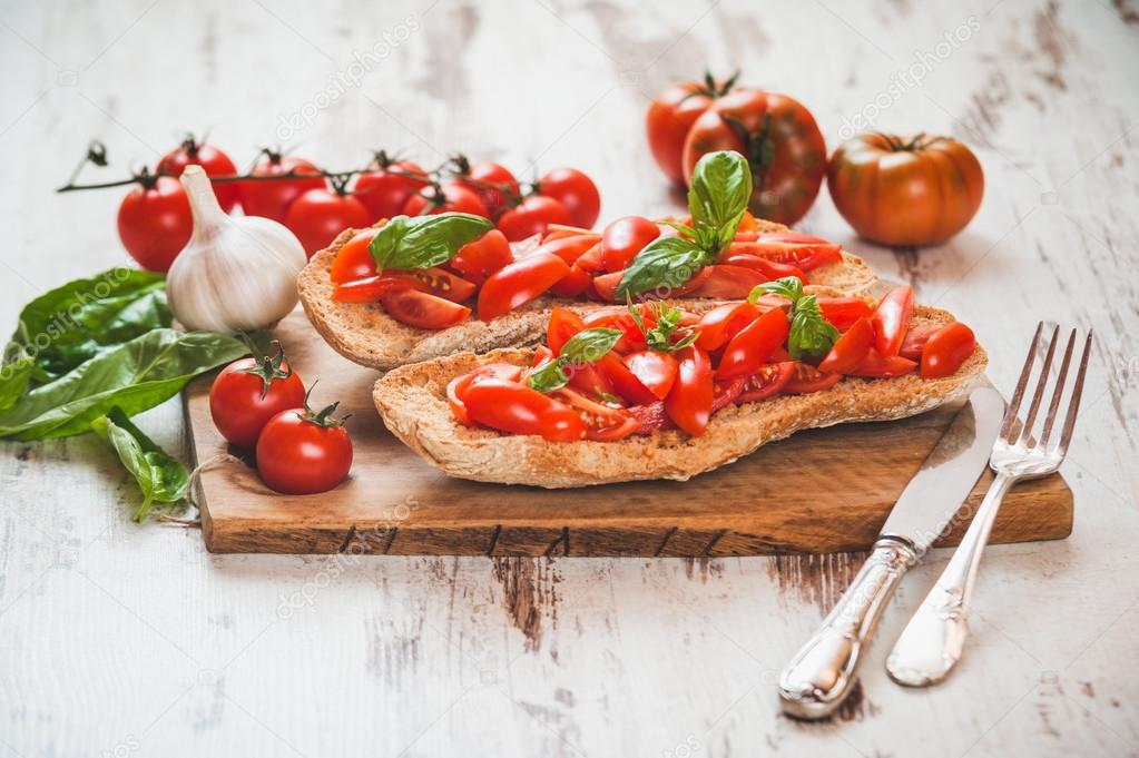 Italian starter, bruschetta with Sicilian red fresh tomato on a 