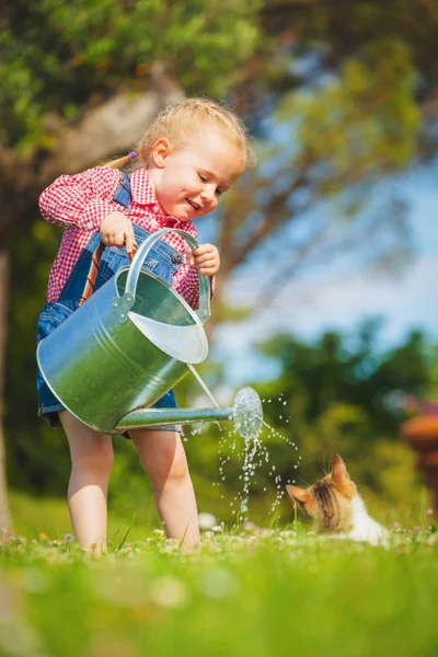 Beautiful smiling little girl helping in the spring work, garden — Stock Photo, Image