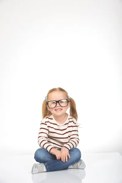 Cute little girl with glasses on a white background Stock Picture