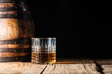 Strong alcohol on a wooden table and barrel clipart
