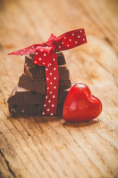 Chocolate with ribbon and heart on St Valentines day love. — Stock Photo, Image