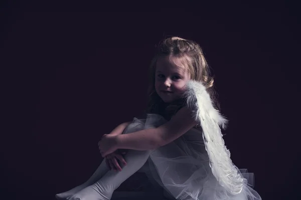 Beautiful blond hair angel on a red background — Stock Photo, Image