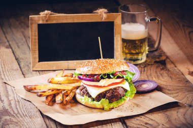 Sulu ve kokulu hamburger vintage tabl üzerinde ev yapımı patates kızartması ile