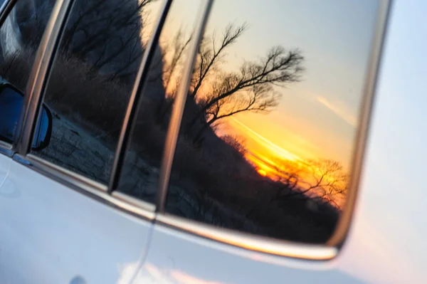 reflection of the autumn sun in the car glass