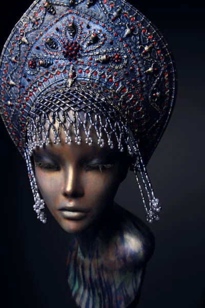 Mannequin in blue head wear with beads