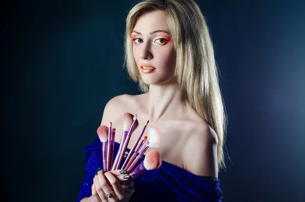 Girl with make-up brushes — Stock Photo, Image