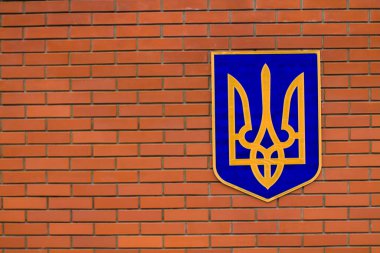 Devlet sembolü. Tuğla bir duvarda Ukrayna arması.