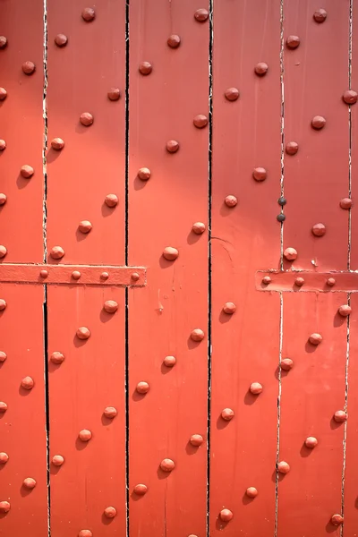 Porta de madeira velha, reforçada com parafusos metálicos . — Fotografia de Stock