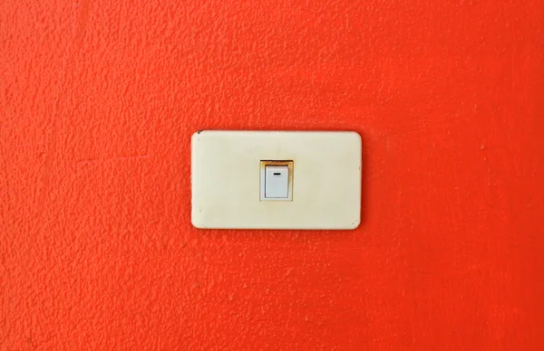 Light switch on a orange wall — Stock Photo, Image