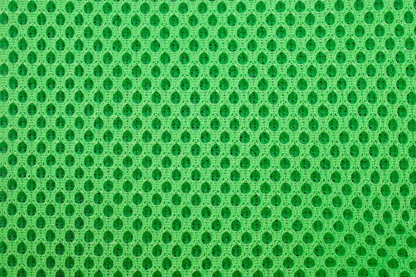green special textile mesh background. Polyester mesh with foam rubber for the manufacture of backpacks. Lining mesh with foam for the inside of a bag or clothes.