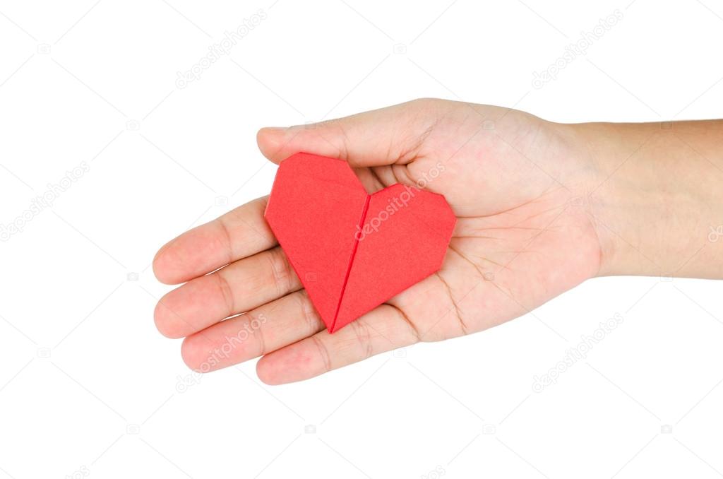 female hand holding paper heart