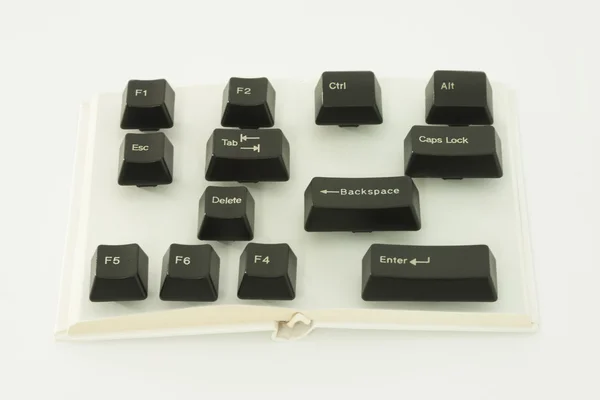 Computer Keys on Book Spread — Stock Photo, Image