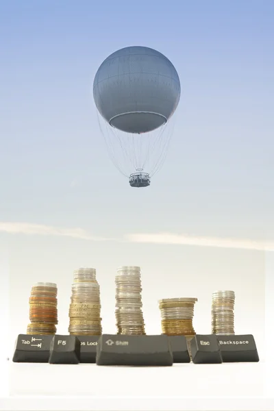 Gas Balloon, Stakes of Coins and Computer Keys against the Sky — Stock Photo, Image