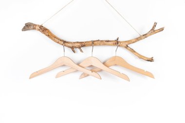 Kalın bir tahta çubukta üç askı, her amaç için harika bir tasarım. Konsept Çevre dostu evler ya da sezon indirimi. Ön görünüm.