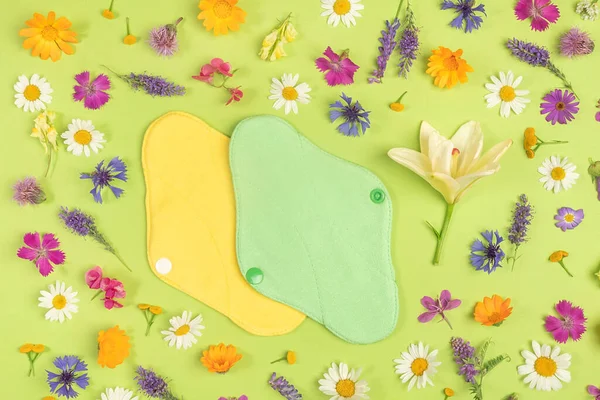 Bamboo charcoal washable sanitary napkins, healthy women's sanitary pads, reusable menstrual pads and colorful natural flowers. Health care and zero-waste, no plastic, eco-friendly concept.