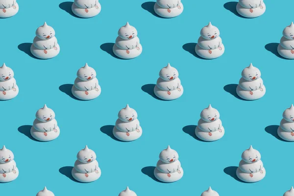 Trendy sunlight pattern made with funny snowmen on blue background, as a backdrop or texture. Minimal winter concept. Wallpaper for your design.