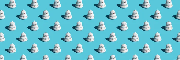 Banner with pattern of funny snowmen on blue background, as a backdrop or texture. Minimal winter concept. Wallpaper for your design.