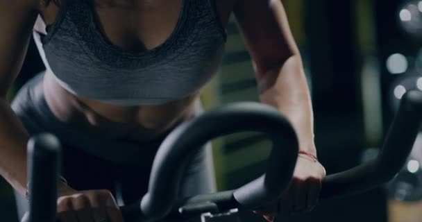 Aantrekkelijke vrouwelijke sporter oefening op stationaire fiets close-up sportcentrum fitness training motivatie gezondheid gericht fitness concept 4k — Stockvideo
