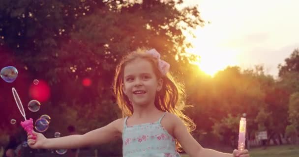 Little Girl Running Through Park At Sunset Making Soap Bubbles Enjoying Childhood Happy Outdoors Play Concept Slow Motion Shot On Red Epic 8K — Stock Video