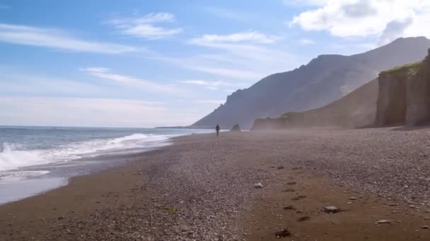 Vuelo aéreo sobre la épica costa del océano Islandia Hombre caminando solo Exploración Geología temprana Libertad Naturaleza increíble — Vídeos de Stock